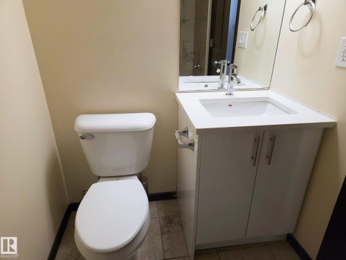 White vanity with integrated rectangular sink and chrome faucet - 11625 88 Street Nw, Edmonton, AB 
