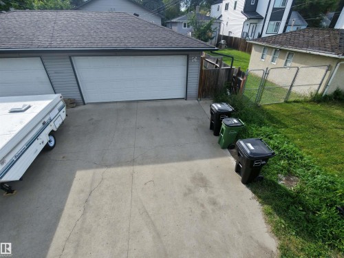 Two-car garage with white paneled doors and a shingled roof - 11625 88 Street Nw, Edmonton, AB 