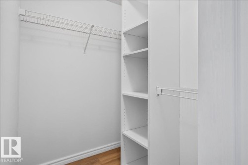 Built-in shelving, wire closet rod system, and wood-finish flooring - #1102 10909 103 Av Nw, Edmonton, AB - Indoor With Storage