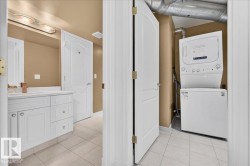 White vanity with under-sink cabinetry and drawers, an integrated sink, and a wall-mounted mirror - 