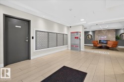 Recessed lighting, wood-finish flooring, built-in mailboxes, and a wall-mounted fireplace with a stone surround - 