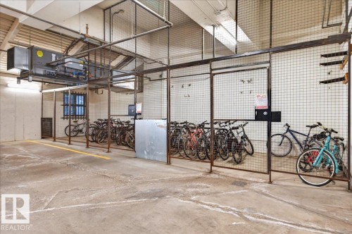 Secure bicycle storage area featuring concrete flooring - #1102 10909 103 Av Nw, Edmonton, AB - Indoor Photo Showing Garage
