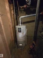 Hot water heater with galvanized steel flue pipe and copper piping - 