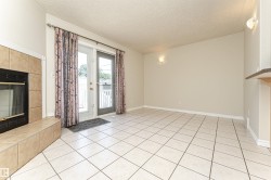 Tiled flooring, fireplace with tiled surround, and glass patio doors - 
