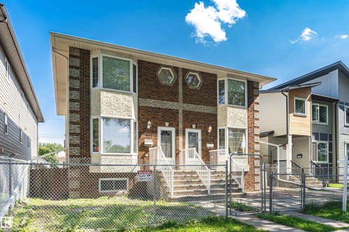 Brick and stucco exterior with two bay windows - 12241 93 Street Nw, Edmonton, AB - Outdoor With Deck Patio Veranda With Facade