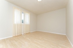 Light-toned wood-finish flooring complements the neutral wall color - 