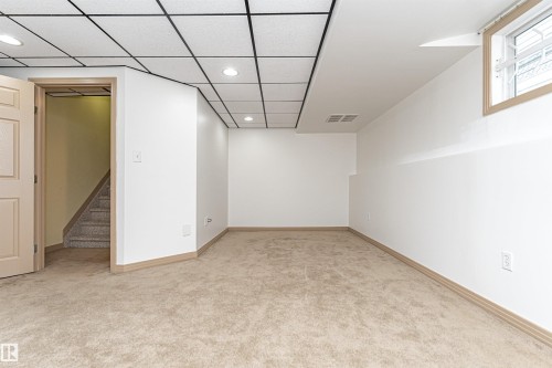 Finished lower level space featuring recessed lighting, a drop ceiling, and a light beige carpet - 12241 93 Street Nw, Edmonton, AB - Indoor Photo Showing Other Room