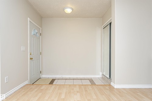 Light-toned wood-finish flooring complements a neutral wall color - 12241 93 Street Nw, Edmonton, AB - Indoor Photo Showing Other Room