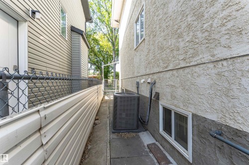 Stucco exterior with a ground-level window - 12241 93 Street Nw, Edmonton, AB - Outdoor With Exterior