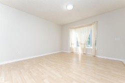Wood-finish flooring, bay window, light wall tones, and recessed ceiling light - 