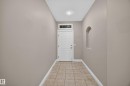 Entryway featuring a white paneled door with an arched transom window, recessed lighting, neutral wall tones, ceramic tile flooring, and an arched wall niche - #401 10178 117 St Nw, Edmonton, AB  - Indoor Photo Showing Other Room 