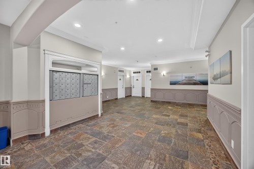 Entryway featuring multi-toned slate flooring, wainscoting, recessed lighting, and wall sconces - #401 10178 117 St Nw, Edmonton, AB - Indoor Photo Showing Other Room