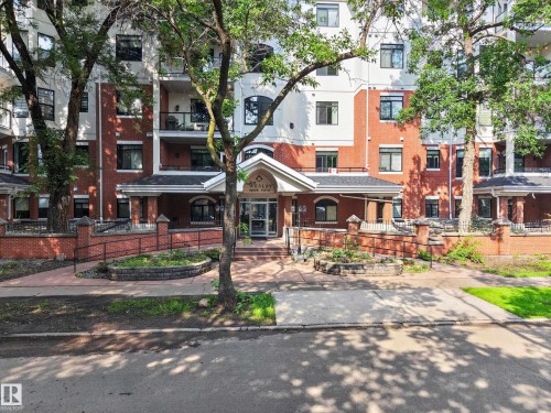 Multi-story residential building featuring a brick and white facade - #401 10178 117 St Nw, Edmonton, AB - Outdoor With Facade