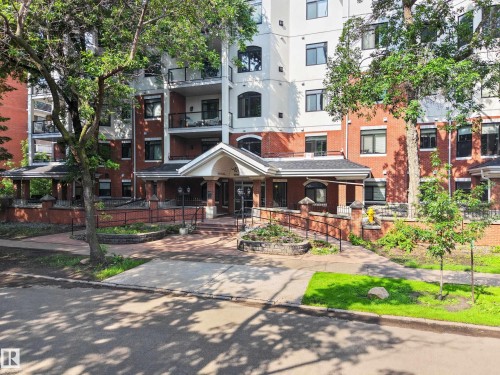 Multi-story building featuring a brick and white facade with multiple balconies - #401 10178 117 St Nw, Edmonton, AB - Outdoor With Facade