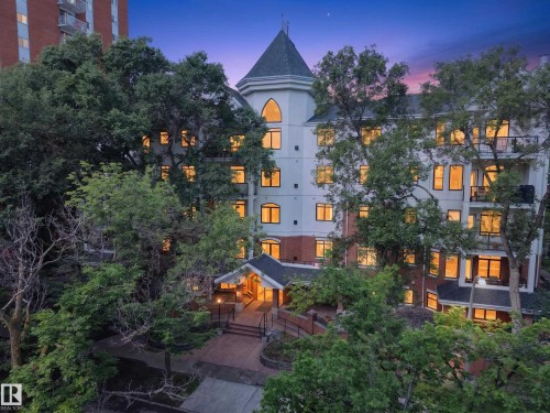 Multi-story building featuring a prominent turret, numerous windows, and a brick and light-colored siding facade - #401 10178 117 St Nw, Edmonton, AB - Outdoor