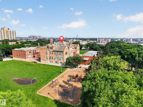 Classic brick building with multiple stories and architectural details situated on a spacious green lawn - #401 10178 117 St Nw, Edmonton, AB - Outdoor With View