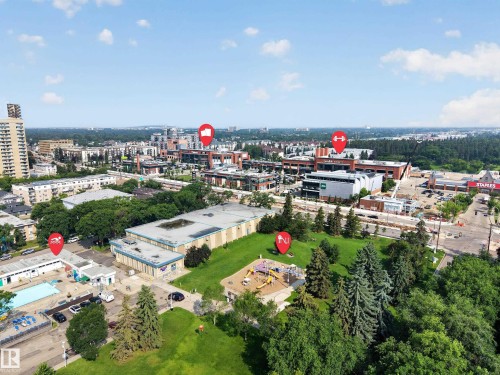 Aerial perspective showcasing a vibrant urban environment with substantial green spaces - #401 10178 117 St Nw, Edmonton, AB - Outdoor With View
