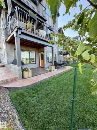 Ground-level patio with stamped concrete, offering an exterior entry point - 7135 Edgemont Way Nw, Edmonton, AB 
