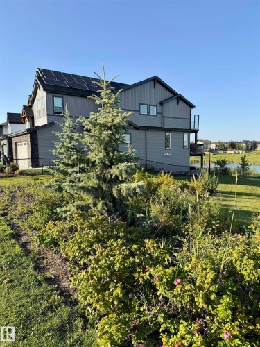 Modern siding exterior with solar panel array - 7135 Edgemont Way Nw, Edmonton, AB 