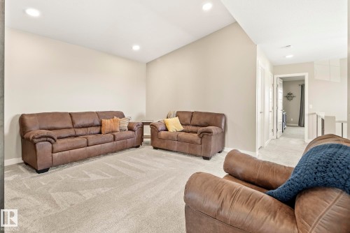 Vaulted ceiling with recessed lighting, light neutral wall color, and light-toned carpet flooring - 7135 Edgemont Way Nw, Edmonton, AB 