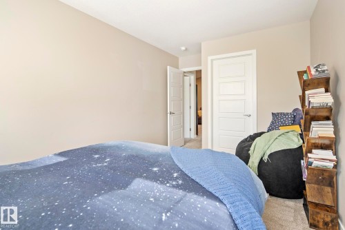 Neutral wall paint, recessed ceiling lighting, light-colored carpeting, white five-panel interior door, and a second white five-panel interior door - 7135 Edgemont Way Nw, Edmonton, AB 