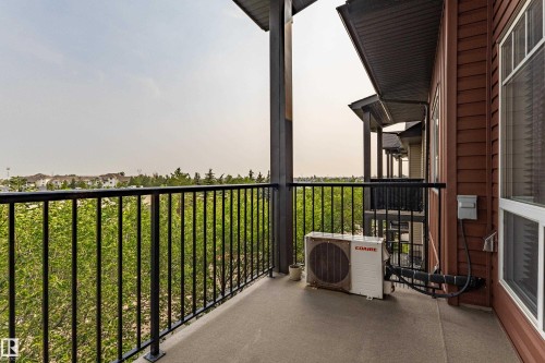 Private balcony with concrete flooring and black metal railings - #407 9523 160 Av Nw, Edmonton, AB - Outdoor With Exterior