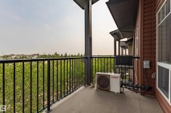 Private balcony with concrete flooring and black metal railings - 