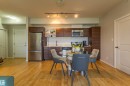 Open-concept kitchen and dining area featuring wood-finish flooring - #407 9523 160 Av Nw, Edmonton, AB  - Indoor 