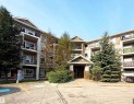 Multi-level building exterior featuring stone accents, covered entry, and individual balconies with black railings - #1111 7339 South Terwillegar Dr Nw, Edmonton, AB  - Outdoor With Facade 