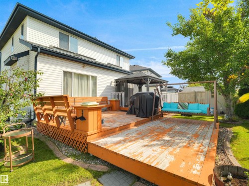 Expansive wooden deck with integrated seating, lattice skirting, and a dedicated shaded gazebo area - 614 Silver Berry Road Nw, Edmonton, AB - Outdoor With Deck Patio Veranda With Exterior