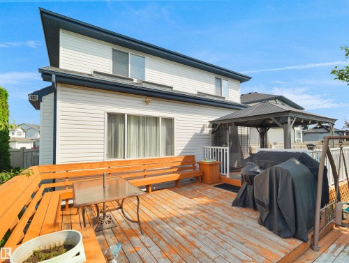 Expansive wood deck with built-in seating, featuring a dark-framed gazebo and privacy lattice - 614 Silver Berry Road Nw, Edmonton, AB - Outdoor With Deck Patio Veranda With Exterior