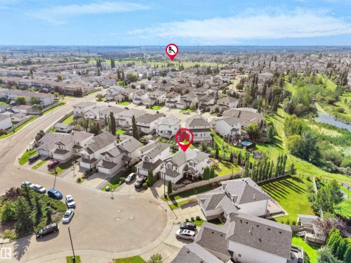 Aerial perspective showcasing a residential neighborhood with detached homes, mature landscaping, and a natural water feature - 614 Silver Berry Road Nw, Edmonton, AB - Outdoor With View