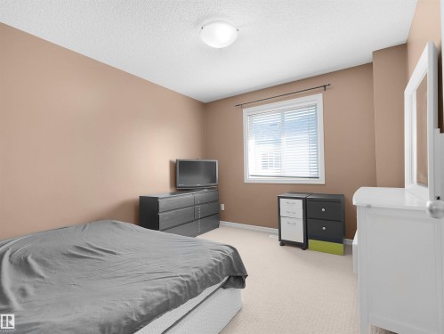 Window with blinds, wall-to-wall carpeting, recessed ceiling light, and neutral wall paint - 614 Silver Berry Road Nw, Edmonton, AB - Indoor Photo Showing Bedroom