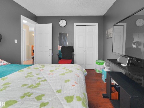 Wood-finish flooring with a smooth texture - 614 Silver Berry Road Nw, Edmonton, AB - Indoor Photo Showing Bedroom