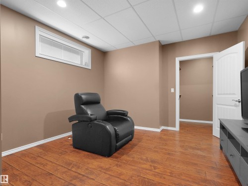 Wood-finish flooring with white trim - 614 Silver Berry Road Nw, Edmonton, AB - Indoor