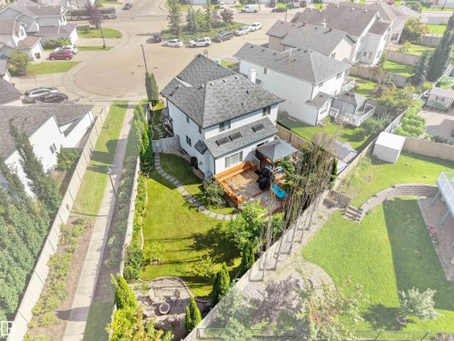 Rear exterior featuring a multi-level wooden deck, stone patio, and a manicured lawn - 614 Silver Berry Road Nw, Edmonton, AB - Outdoor With View