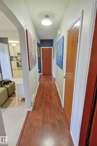 Wood-finish flooring throughout the hallway - 11739 129 Street Nw, Edmonton, AB 