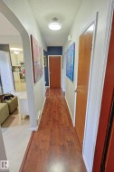 Wood-finish flooring throughout the hallway - 