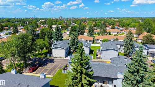Aerial perspective showcasing residential buildings with gray siding and dark shingled roofs - #10 1415 62 St Nw, Edmonton, AB - Outdoor With View