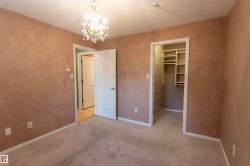 Textured wall finish with a built-in closet featuring shelving and a hanging rod - 