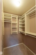 Custom closet organization system featuring shelving and hanging rods - 