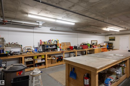 Exposed ceiling with ductwork and overhead lighting - #204 2420 108 St Nw, Edmonton, AB - Indoor Photo Showing Garage