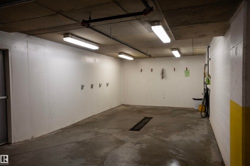 Concrete flooring with integrated drainage system - #204 2420 108 St Nw, Edmonton, AB - Indoor Photo Showing Garage