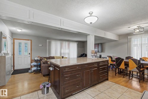 Kitchen island with cabinetry and stone-finish countertop - 4323 114B Street Nw, Edmonton, AB - Indoor