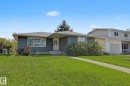 Ranch-style residence featuring horizontal siding, a gabled roof, and a front yard with a concrete pathway - 4323 114B Street Nw, Edmonton, AB  - Outdoor 