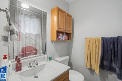 Vanity with integrated sink, chrome faucet, and framed wall mirror - 