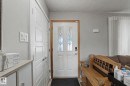 Entry door with decorative glass inserts and wood trim - 4323 114B Street Nw, Edmonton, AB  - Indoor Photo Showing Other Room 