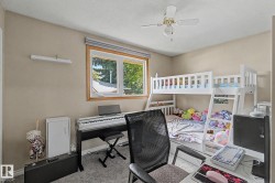 Neutral wall color, window with wood-finish trim, ceiling fan with integrated lighting, carpeted flooring - 