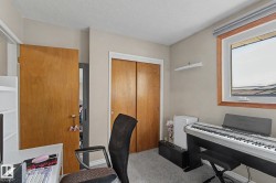 Recessed window with wood-finish trim, light grey wall paint, and grey carpet flooring - 