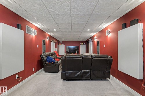Spacious room featuring a drop ceiling with recessed lighting, carpet flooring, wall-mounted sconces, and acoustic panels - 4323 114B Street Nw, Edmonton, AB - Indoor Photo Showing Other Room